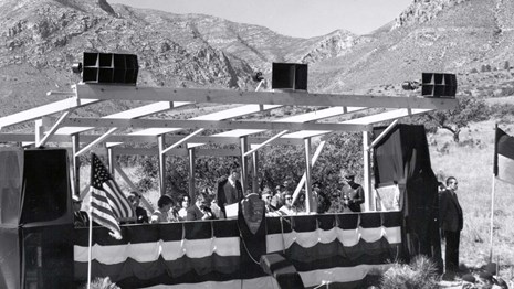 A black and white photograph of a speakers platform with bunting