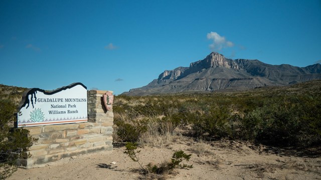 Park entry sign in the desert below El Capitan