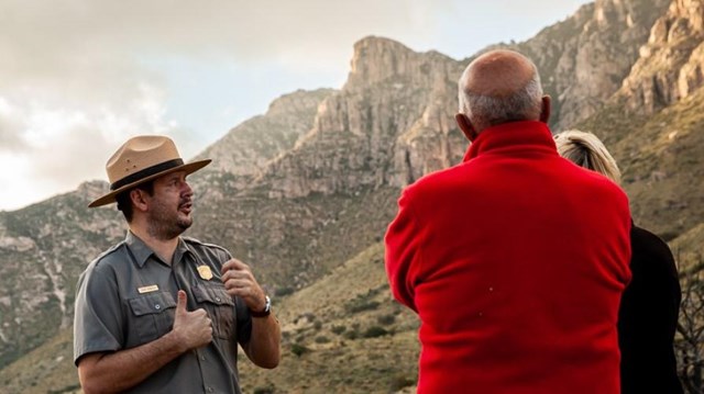 A park ranger visits with a family