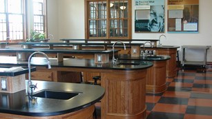 Image of George Washington Carver science classroom with brown lab tables and brown & black floor.