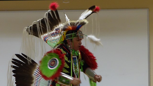 A man dressed in Native American regalia. 