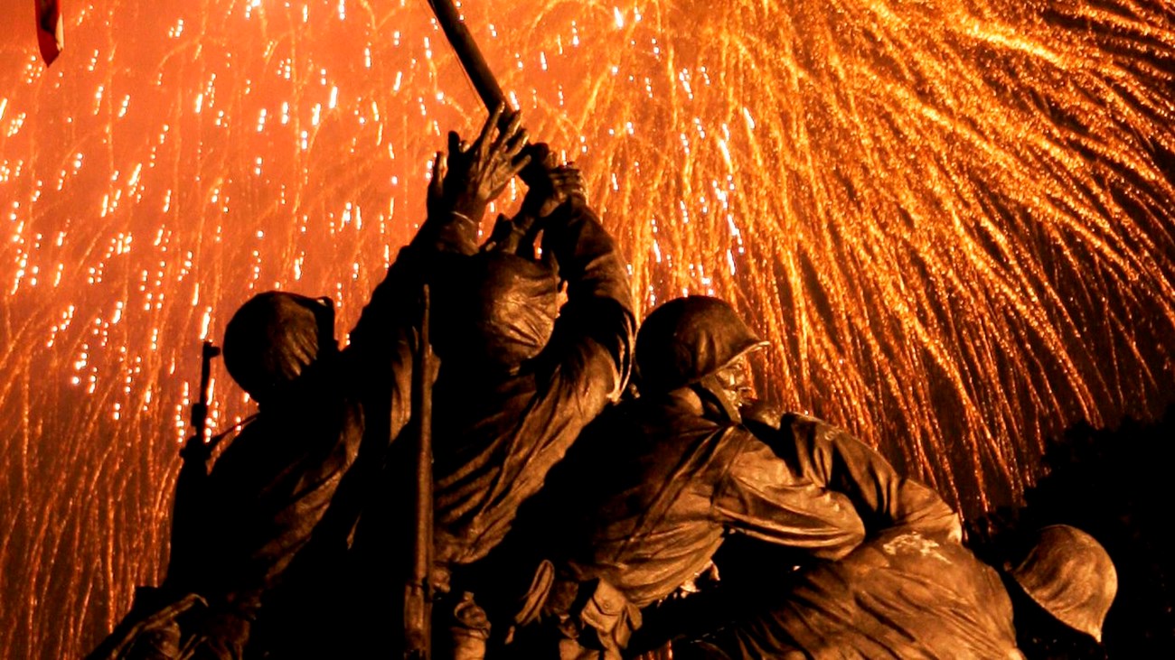 Fireworks illuminate the sky behind the United States Marine Corps War Memorial.