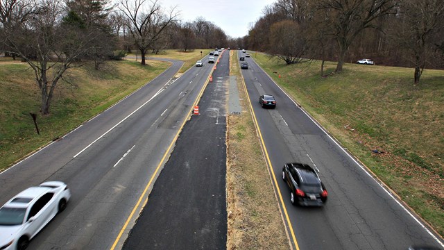 A parkway with cars driving on it.