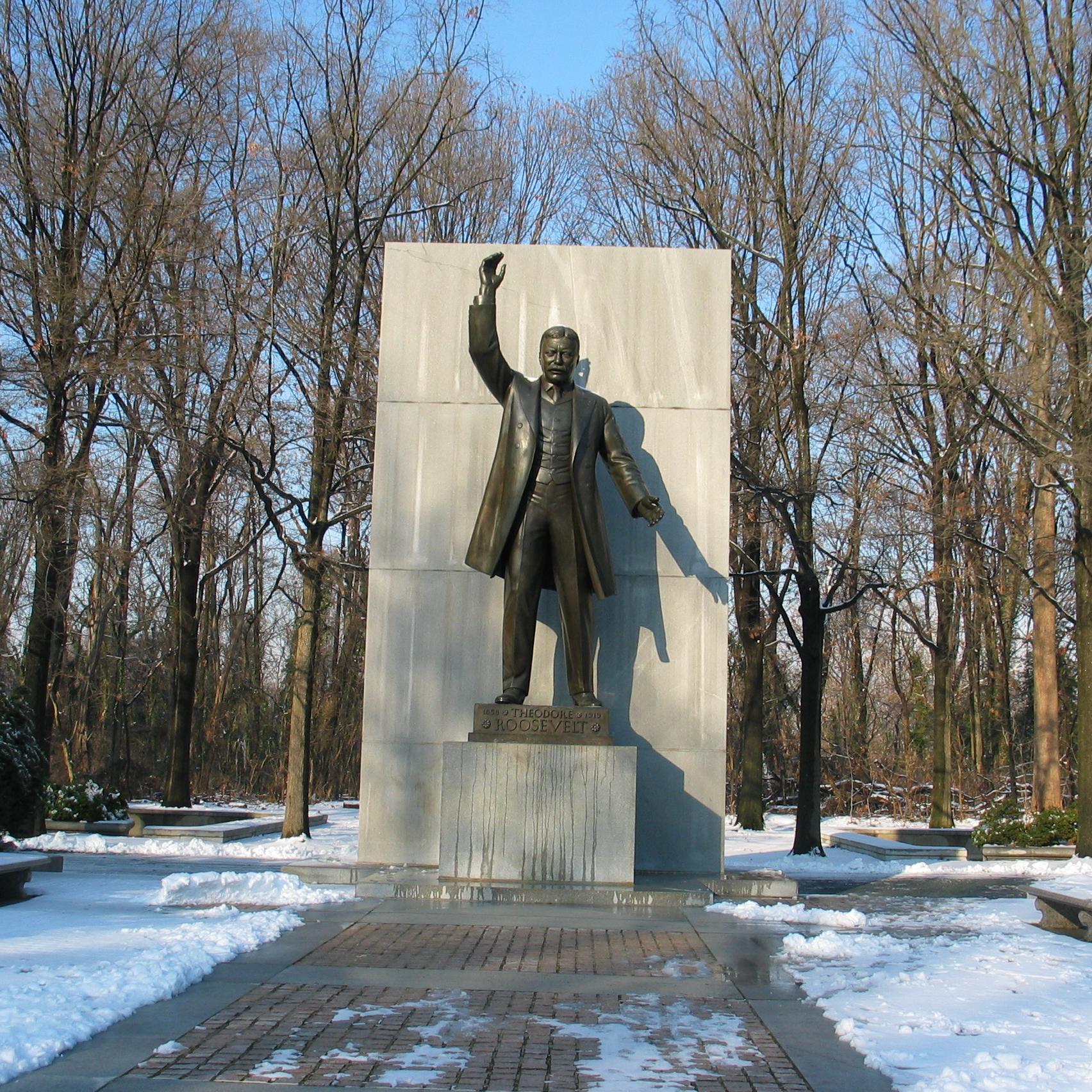 A statue of Theodore Roosevelt in the snow.