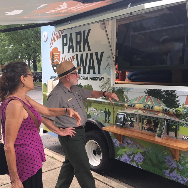 Park Ranger shows the Mobile Visitor Center to visitor.