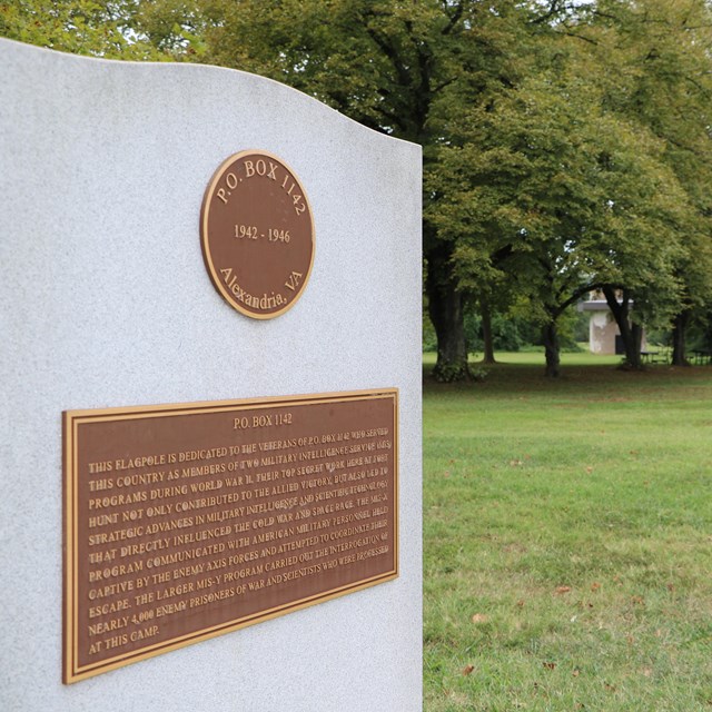 A monument in a grass field.