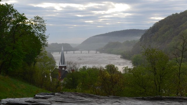 foggy view of the river and gap in the mountains from Jefferson Rock; church steeple is visible