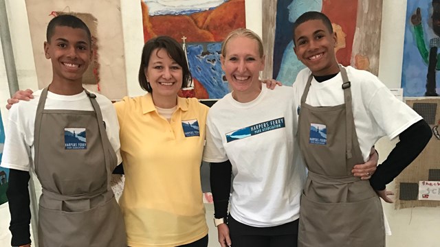 people wearing Harpers Ferry Park Association shirts smile for the camera