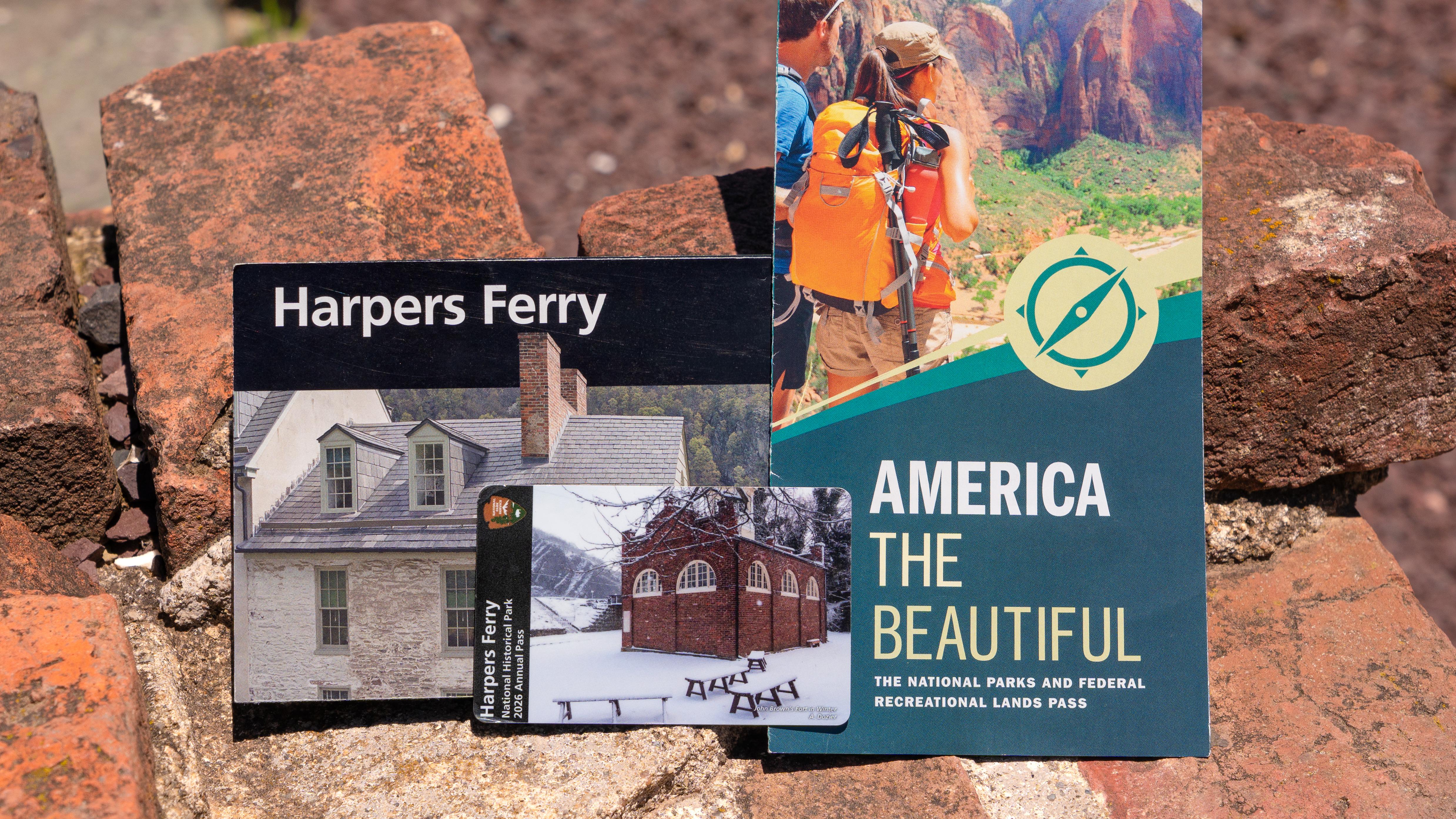 Entrance pass laying on top of pass brochure.
