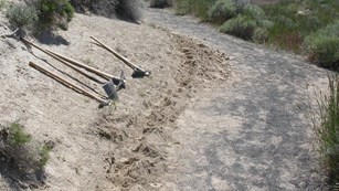 shovels off trail side