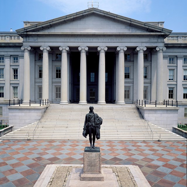 A columned building with a Hamilton Statue out front.