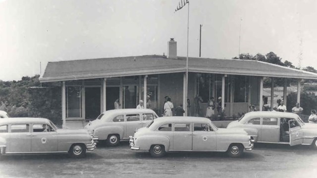 Headquarters visitor center with cars. 