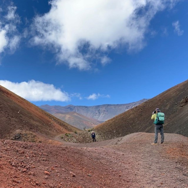 two hikers between two cinder cone hills