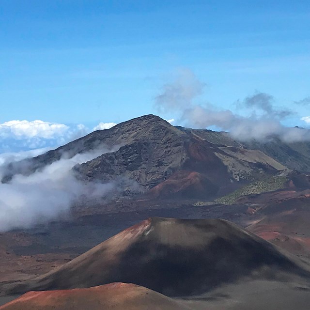Clouds creep into an expansive volcanic crater