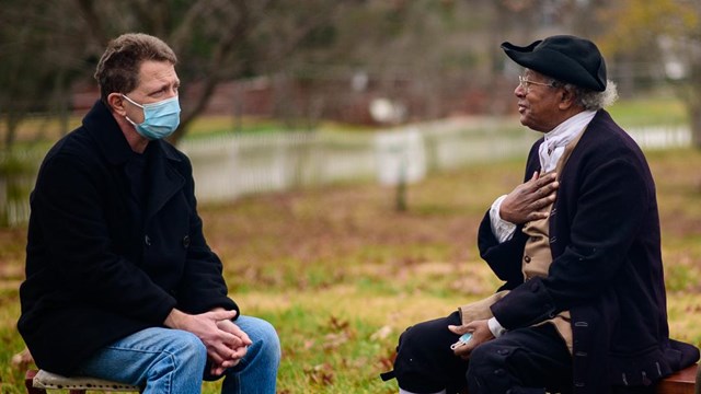 Living historians talk to a visitor.