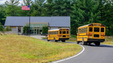 buses driving in front of the visitor center