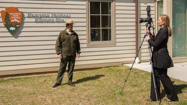 A photographer taking pictures of a ranger