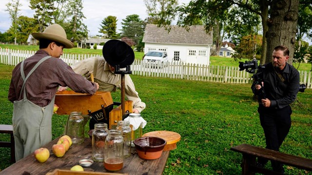 A visitor photographing living historians at Hampton.