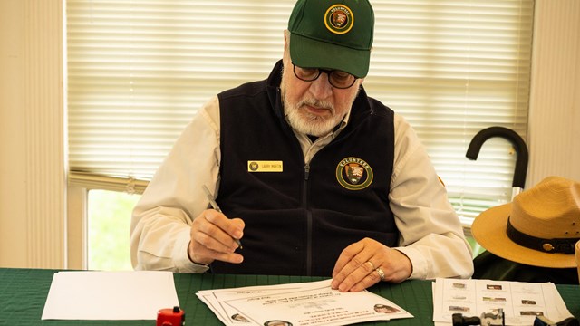 A park volunteer filling out a form.