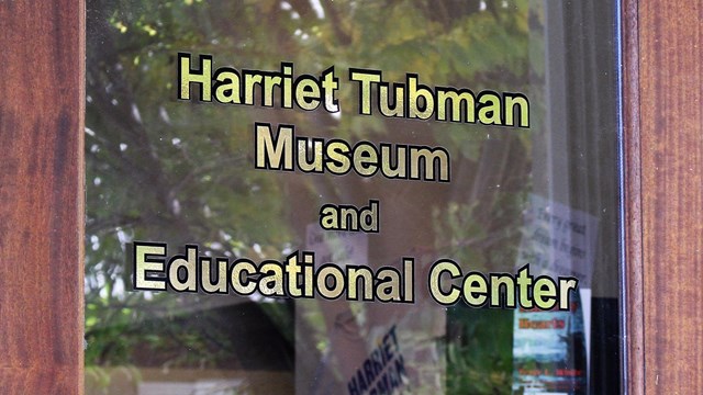 Glass door to the museum reads "Harriet Tubman Museum and Educational Center"