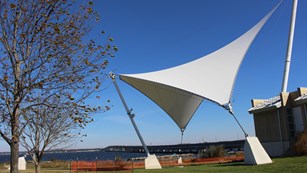Deep blue skies outside the Dorchester County Visitor Center, with sail-reminiscent figure in front