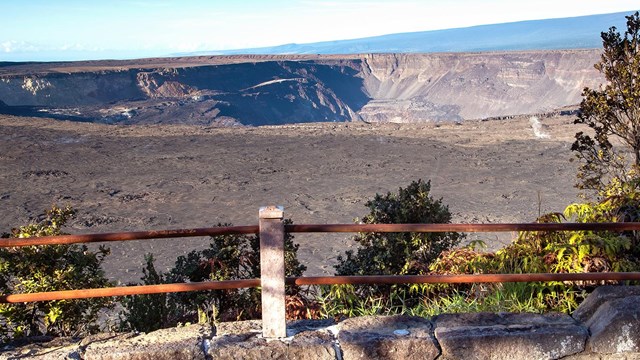 Overlook into a volcanic crater with trees in the foreground