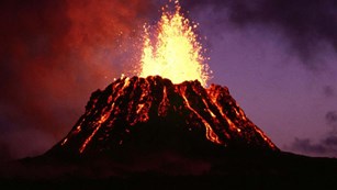 Erupting lava cone at night
