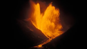 Erupting lava fountain at night