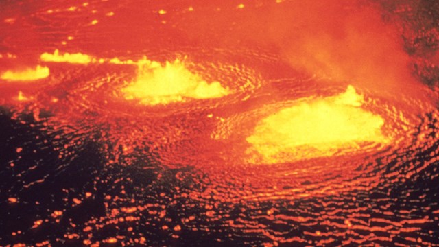 Glowing orange molten lava lake from above.