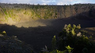 Sun setting on a volcanic pit crater