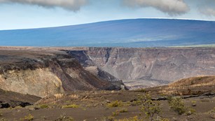 Ranger in front of volcanic caldera