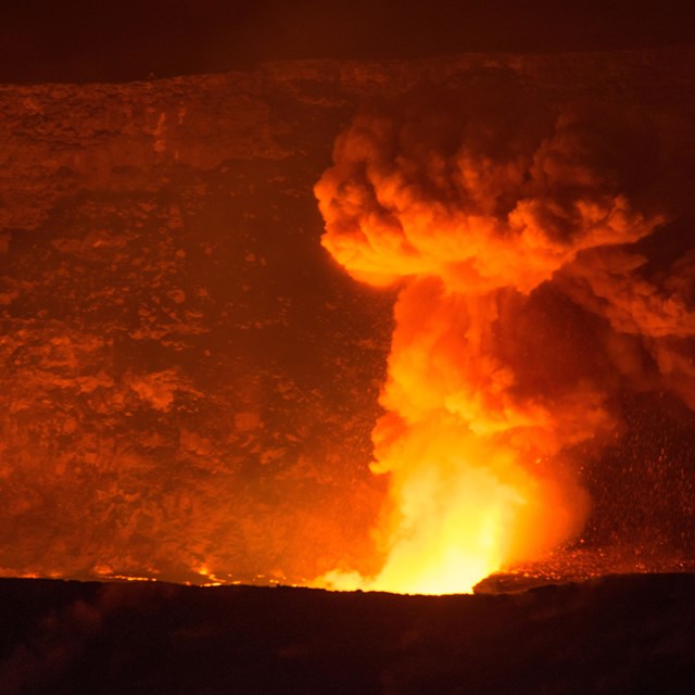 a firey read glow of lava at night