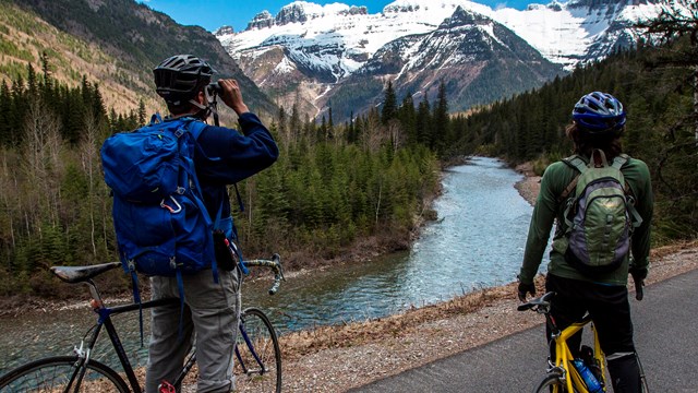 Two visitors pause bike ride to enjoy the mountain view