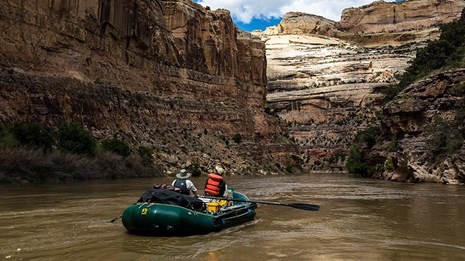 Two men in raft on river