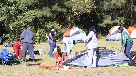 A group taking down their tents 
