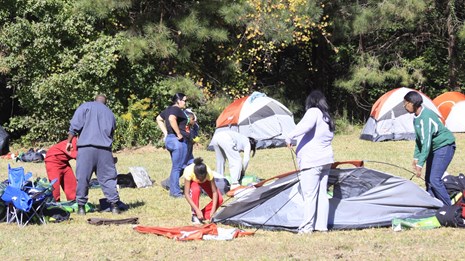 A group taking down their tents