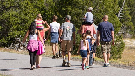 Visitors walking in the Upper Geyser Basin at Yellowstone
