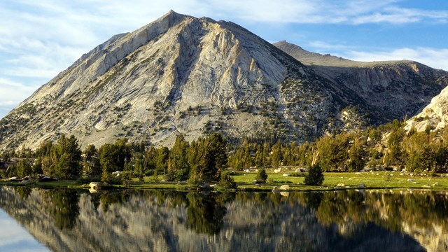 view of water featuring a tall mountain and sky in the background