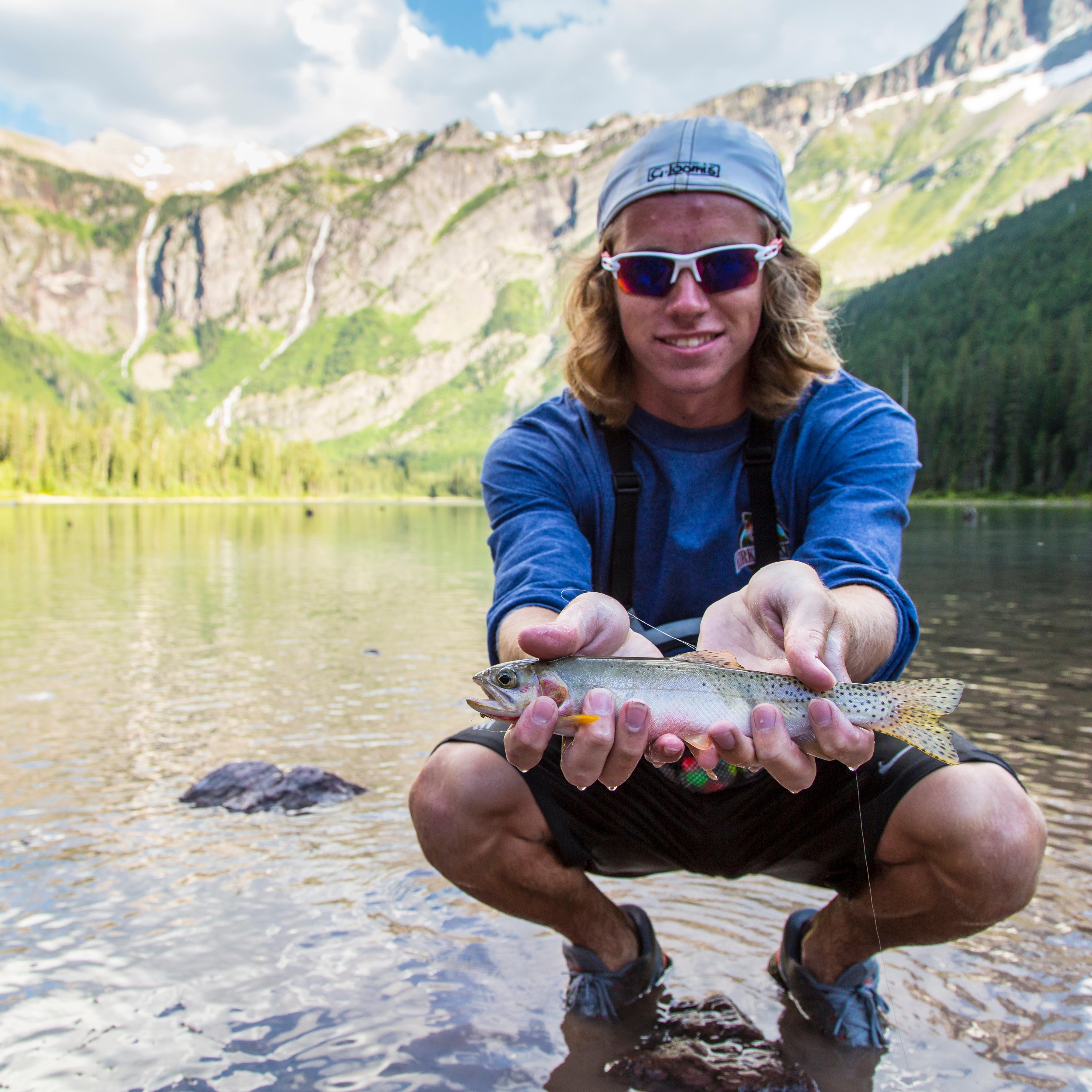 Boy holds fish in his hands