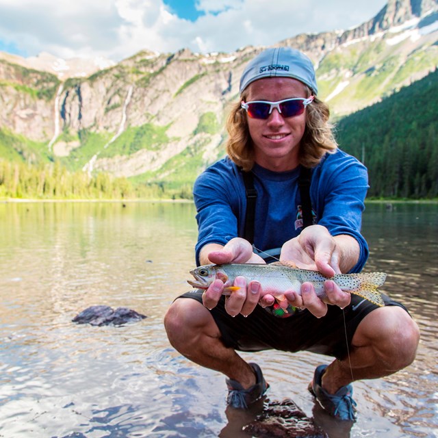 Boy holds fish in his hands