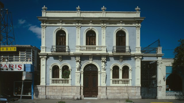 Front facade of light blue house with white trim and details