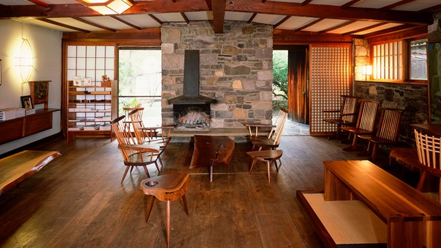 Interior of modern living room with furniture around stone fireplace