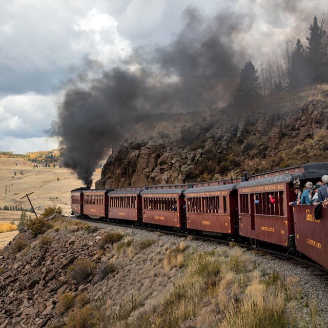 Cumbres & Toltec Scenic Railroad - smoke coming from red train on tracks in mountains