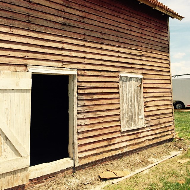 Exterior image of a barn on a sunny day
