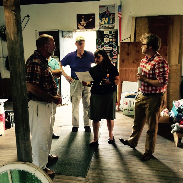 Group of people standing inside a building talking to each other