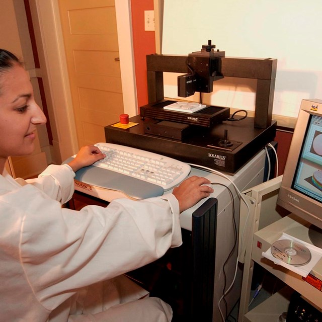A woman views a 3D scan on a computer monitor