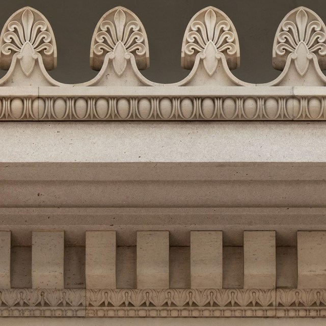 The cornice, frieze, and architrave of a historic structure