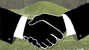 A grass-covered mound in the background with an artistic rendering of a handshake