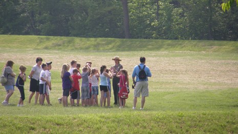 A group of students and teachers walk with a ranger