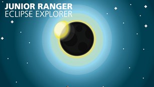 The Eclipse Explorer booklet showing the moon passing in front of the sun over a mountainous terrain